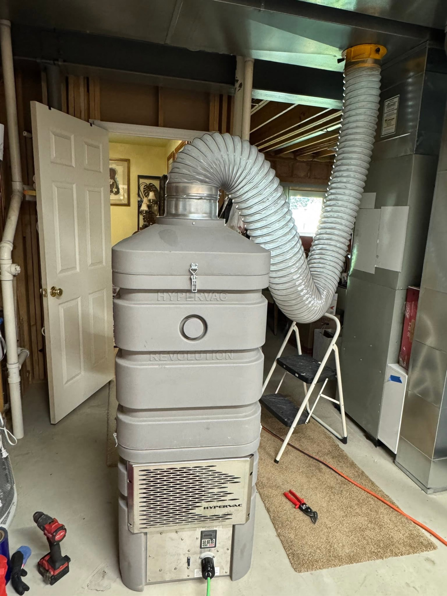 Our HEPA-filtered negative air vacuum connected to a home's main trunk line during an air duct cleaning